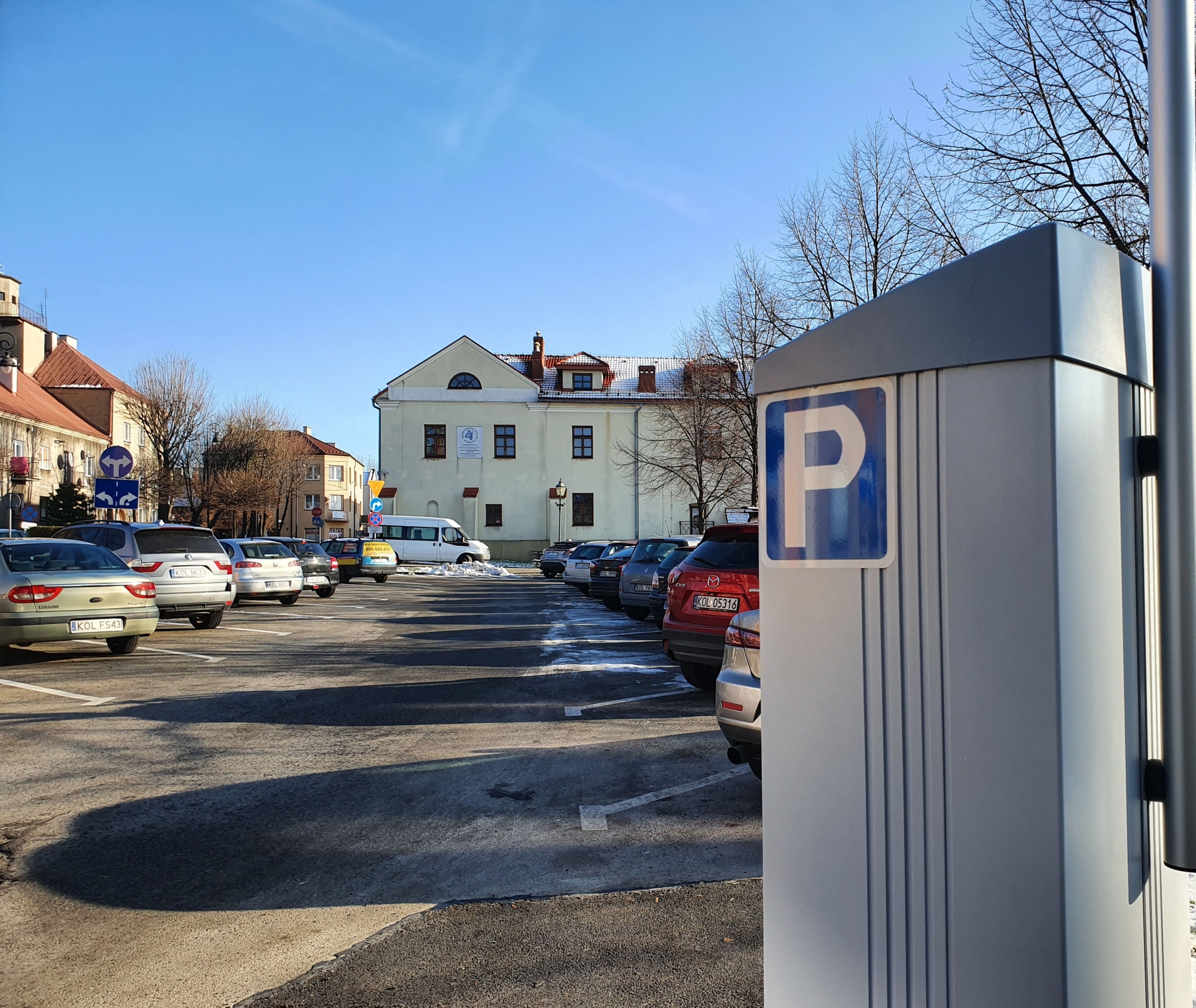 Widok parkomatu, w tle parking